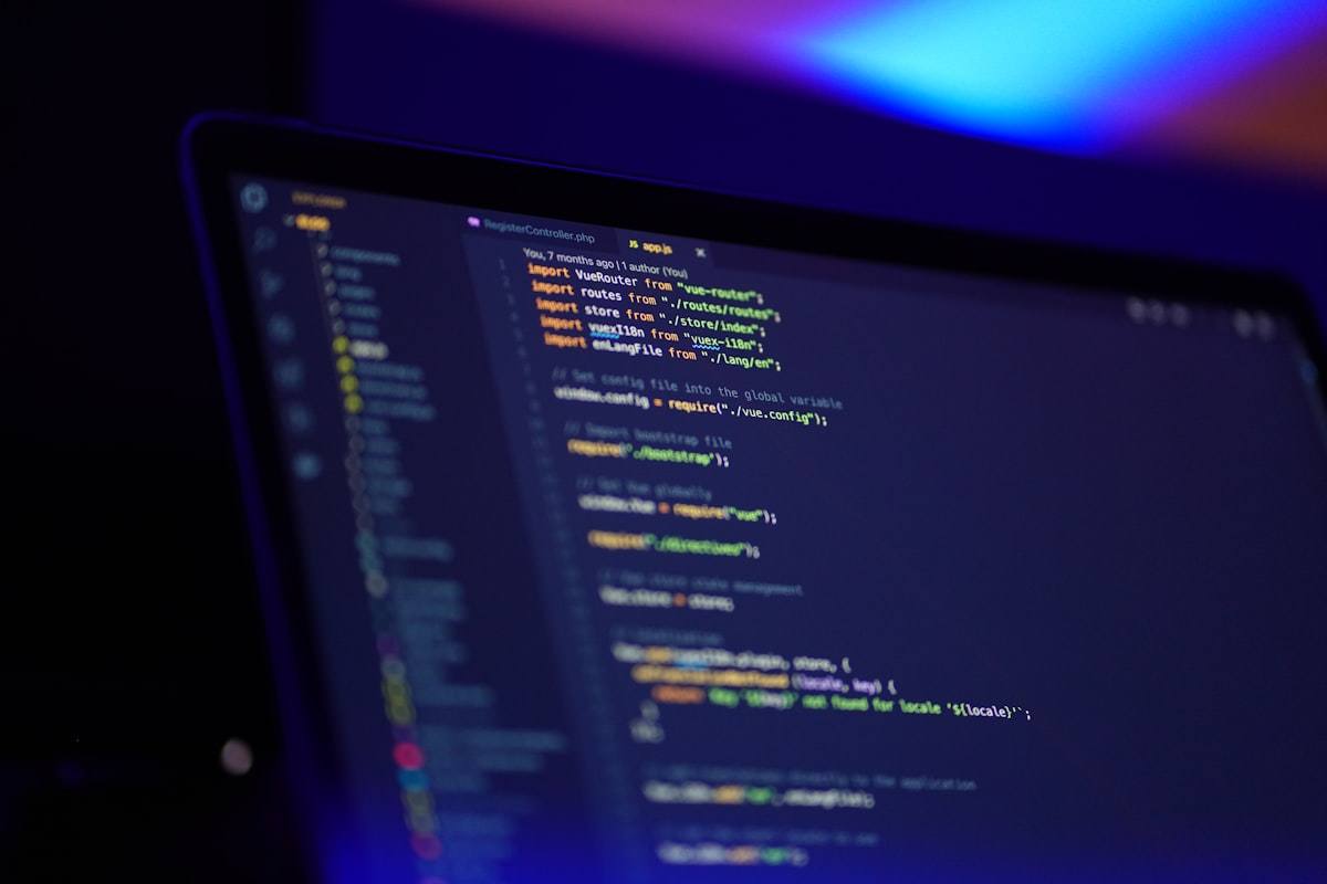 Laptop screen showing code for a website build.
